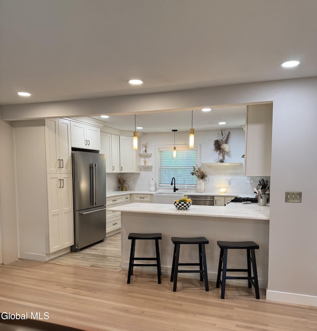 32 Winnie St, Albany, NY 12208 - kitchen with freestanding refrigerator, open shelves, a peninsula, a kitchen bar, and recessed lighting