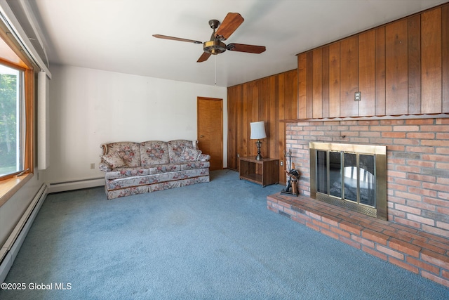 921 Altamont Voorheesville Rd, Altamont, NY 12009 - unfurnished living room with a ceiling fan, a fireplace, wooden walls, a baseboard radiator, and carpet floors