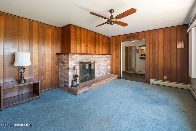 921 Altamont Voorheesville Rd, Altamont, NY 12009 - unfurnished living room with ceiling fan, wood walls, carpet flooring, a fireplace, and baseboard heating