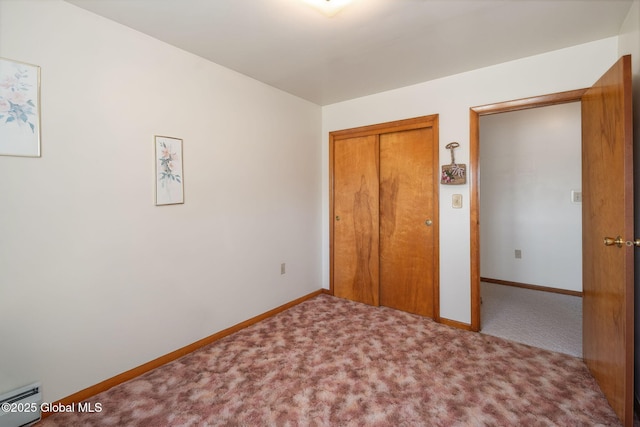 921 Altamont Voorheesville Rd, Altamont, NY 12009 - unfurnished bedroom featuring a baseboard heating unit, carpet, and a closet
