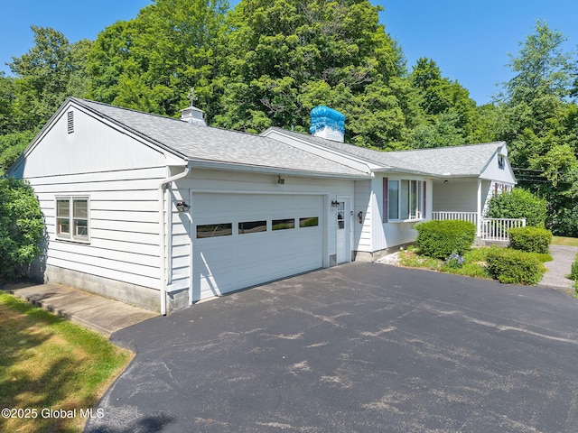 921 Altamont Voorheesville Rd, Altamont, NY 12009 - ranch-style house with a garage, a chimney, driveway, and covered porch