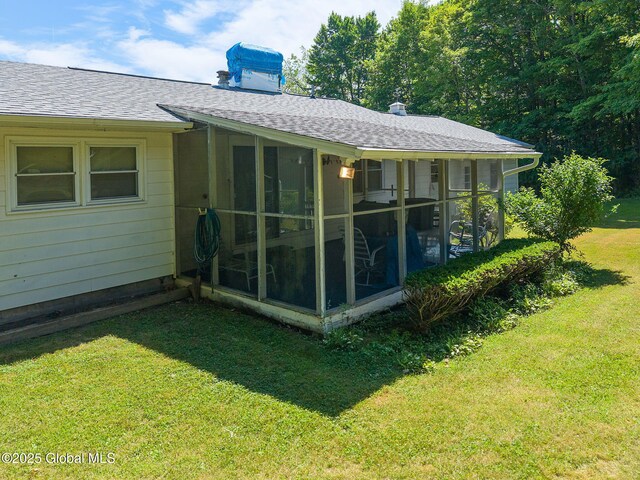 921 Altamont Voorheesville Rd, Altamont, NY 12009 - back of property with a shingled roof, a chimney, a sunroom, and a yard