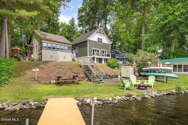 2235 Oaks Rd, Argyle, NY 12809 - back of property featuring a fire pit, stairway, a shed, a yard, and a sunroom