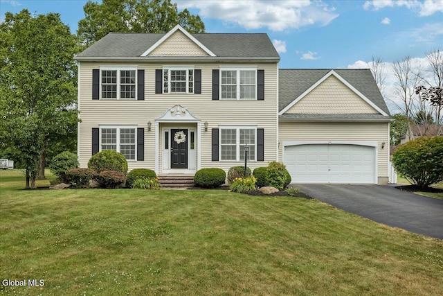 3 Lucille Ln, Malta, NY 12019 - colonial house featuring asphalt driveway, a garage, and a front lawn