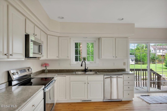 3 Lucille Ln, Malta, NY 12019 - kitchen featuring stainless steel appliances, healthy amount of natural light, white cabinets, and dark countertops