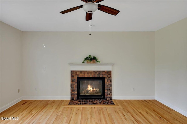 3 Lucille Ln, Malta, NY 12019 - unfurnished living room with wood finished floors, ceiling fan, and a fireplace