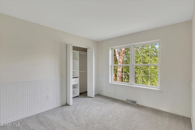 3 Lucille Ln, Malta, NY 12019 - unfurnished bedroom featuring a wainscoted wall and carpet flooring