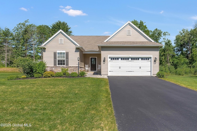 55 Winterberry Ln, Moreau, NY 12828 - view of front of home with an attached garage, asphalt driveway, a front lawn, stone siding, and a shingled roof