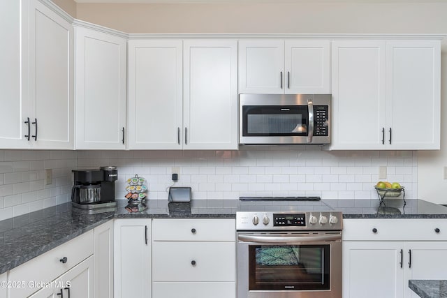 55 Winterberry Ln, Moreau, NY 12828 - kitchen with appliances with stainless steel finishes, white cabinetry, tasteful backsplash, and dark stone counters