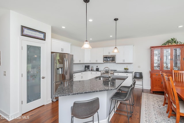 55 Winterberry Ln, Moreau, NY 12828 - kitchen featuring appliances with stainless steel finishes, dark wood-style floors, decorative backsplash, white cabinetry, and recessed lighting