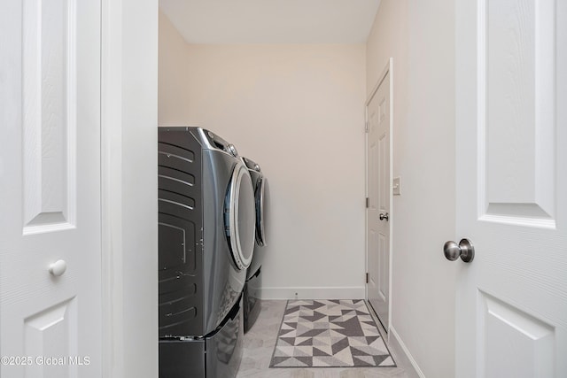 55 Winterberry Ln, Moreau, NY 12828 - washroom with washing machine and clothes dryer and baseboards