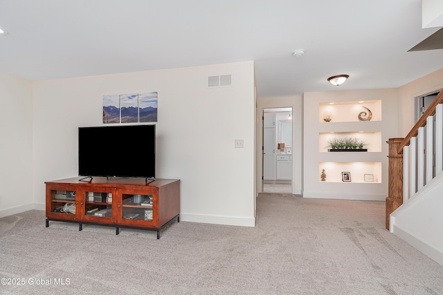 55 Winterberry Ln, Moreau, NY 12828 - carpeted living area with stairs and baseboards