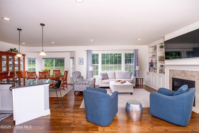 55 Winterberry Ln, Moreau, NY 12828 - living room with dark wood-style floors, recessed lighting, a fireplace, and built in features