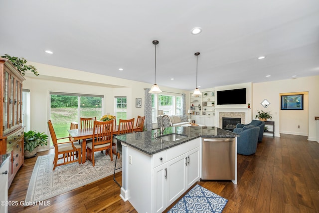 55 Winterberry Ln, Moreau, NY 12828 - kitchen featuring dishwasher, a glass covered fireplace, dark stone counters, dark wood-style floors, and recessed lighting