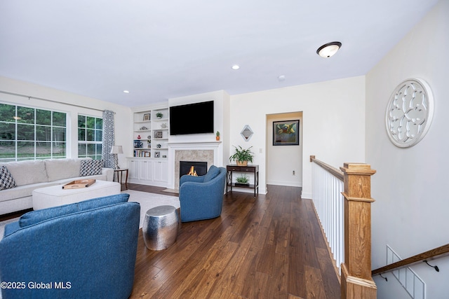 55 Winterberry Ln, Moreau, NY 12828 - living room featuring dark wood-style flooring, a fireplace with flush hearth, recessed lighting, and built in features