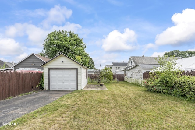 1633 Chrisler Ave, Schenectady, NY 12303 - view of yard featuring asphalt driveway, an outbuilding, and a garage