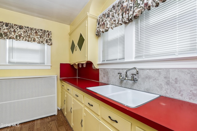 1633 Chrisler Ave, Schenectady, NY 12303 - kitchen featuring radiator heating unit, cream cabinets, and dark wood-style floors