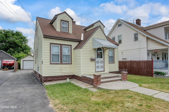 1633 Chrisler Ave, Schenectady, NY 12303 - view of front of house with a detached garage, an outbuilding, and a shingled roof