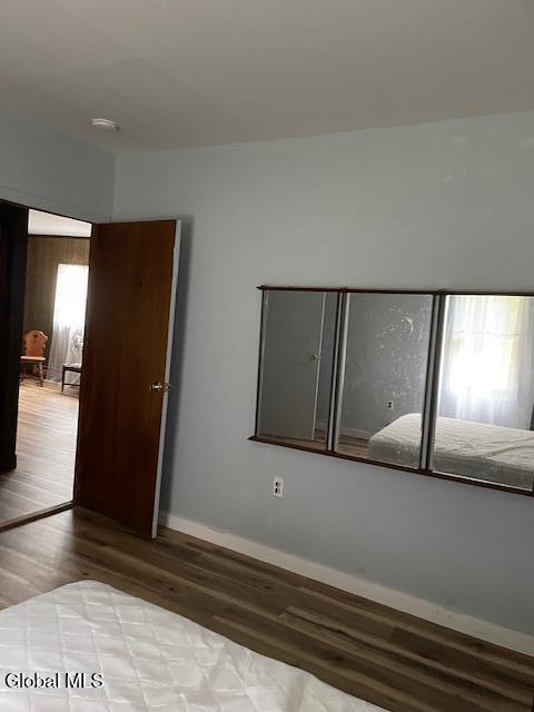 129 Moan And Groan Rd, Hope, NY 12134 - unfurnished bedroom featuring wood finished floors and baseboards