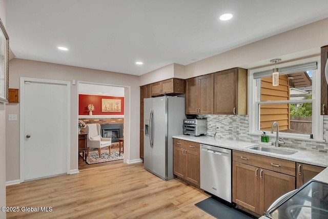 15 Deer Path Dr, Colonie, NY 12205 - kitchen featuring appliances with stainless steel finishes, backsplash, light wood-type flooring, recessed lighting, and pendant lighting