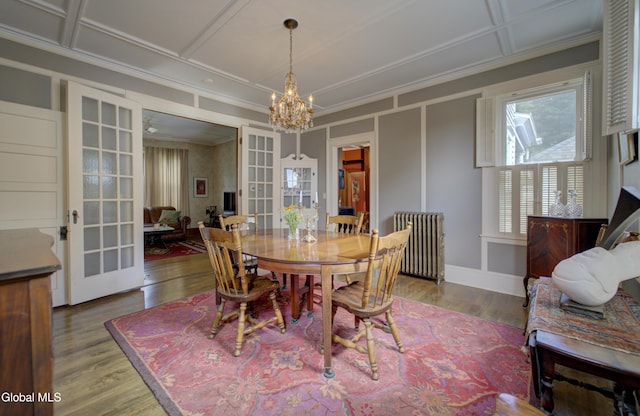 202 W 1st Ave, Johnstown, NY 12095 - dining area featuring radiator heating unit, french doors, a chandelier, wood finished floors, and crown molding