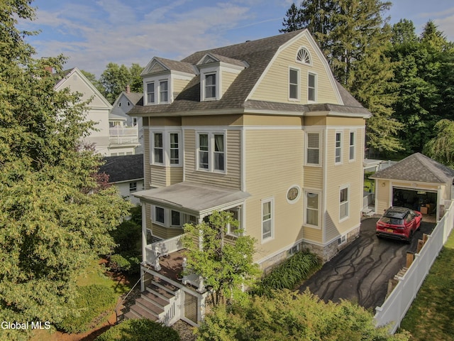 202 W 1st Ave, Johnstown, NY 12095 - view of front of house with roof with shingles, a garage, and an outdoor structure
