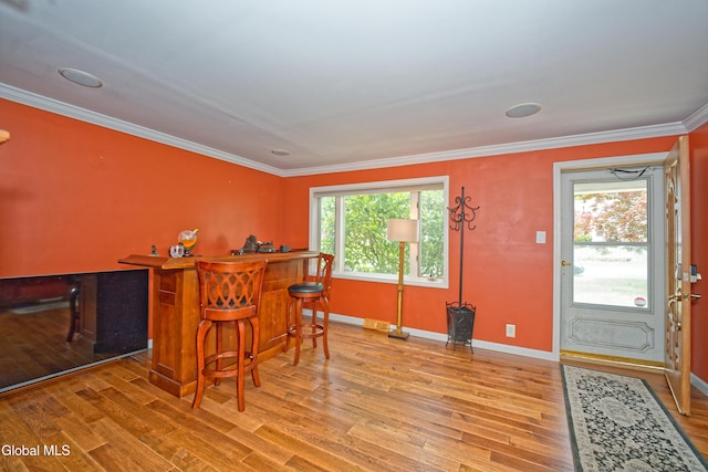 2834 Halsey Dr, Schenectady, NY 12304 - dining area with a bar, wood finished floors, and ornamental molding