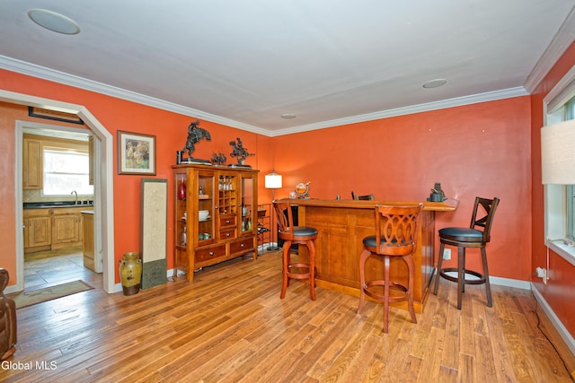 2834 Halsey Dr, Schenectady, NY 12304 - indoor dry bar with light wood-style floors, crown molding, and arched walkways