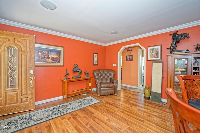 2834 Halsey Dr, Schenectady, NY 12304 - sitting room with wood finished floors, arched walkways, and crown molding
