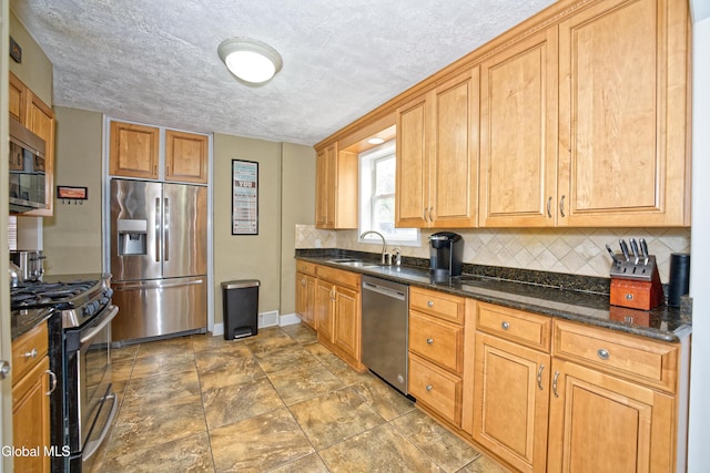 2834 Halsey Dr, Schenectady, NY 12304 - kitchen featuring stainless steel appliances, decorative backsplash, dark stone countertops, and a textured ceiling