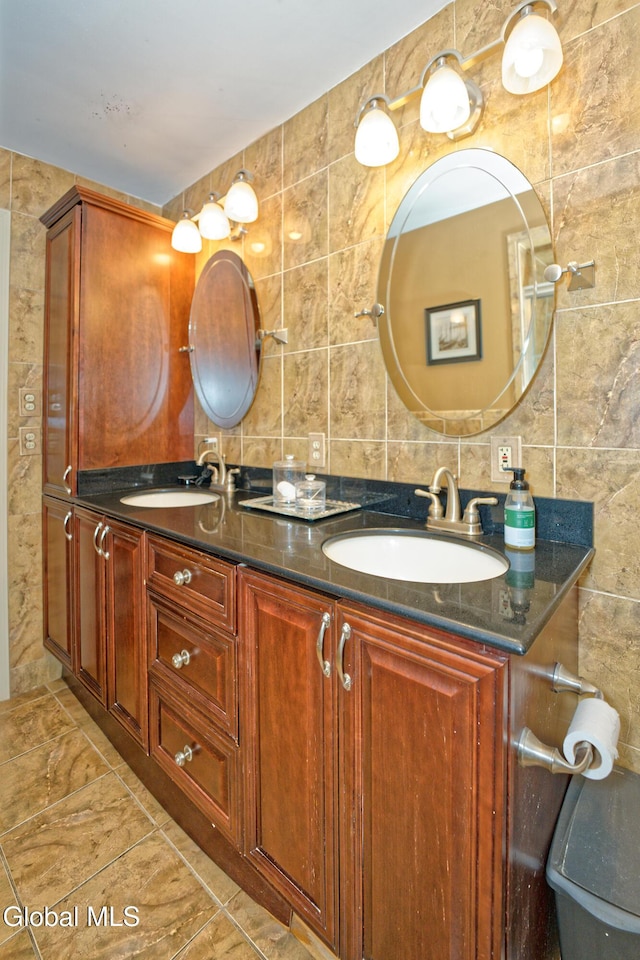 2834 Halsey Dr, Schenectady, NY 12304 - bathroom with tile walls, double vanity, marble finish floors, and backsplash