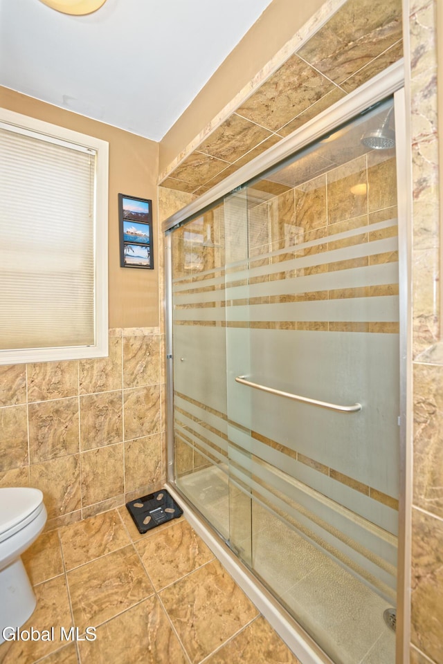 2834 Halsey Dr, Schenectady, NY 12304 - bathroom with tile walls, a shower stall, wainscoting, and tile patterned flooring