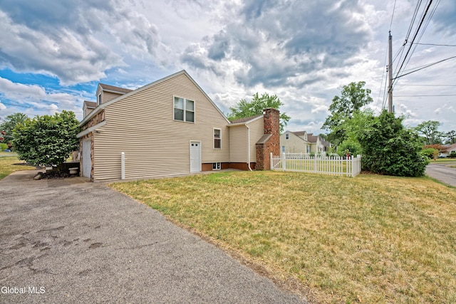 2834 Halsey Dr, Schenectady, NY 12304 - back of property with asphalt driveway and a garage