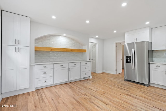 479 Albany Shaker Rd, Colonie, NY 12211 - kitchen featuring stainless steel fridge with ice dispenser, light wood-style flooring, white cabinets, and recessed lighting