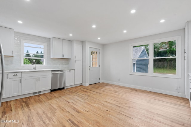 479 Albany Shaker Rd, Colonie, NY 12211 - kitchen featuring dishwasher, light countertops, light wood-type flooring, recessed lighting, and backsplash