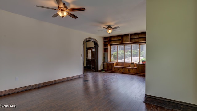 200 Fon Clair St, Johnstown, NY 12095 - spare room with ceiling fan, arched walkways, and dark wood-type flooring