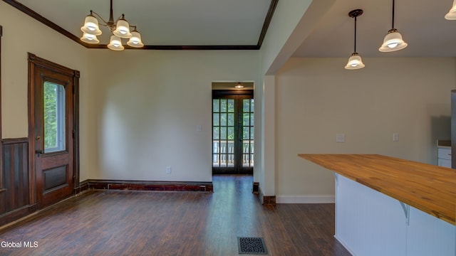 200 Fon Clair St, Johnstown, NY 12095 - unfurnished dining area with dark wood finished floors, crown molding, and a chandelier
