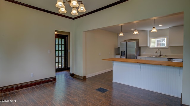 200 Fon Clair St, Johnstown, NY 12095 - kitchen featuring stainless steel fridge, wooden counters, a chandelier, dark wood finished floors, and crown molding
