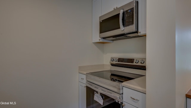 200 Fon Clair St, Johnstown, NY 12095 - kitchen featuring stainless steel appliances, light countertops, and white cabinets