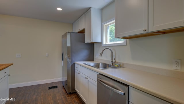 200 Fon Clair St, Johnstown, NY 12095 - kitchen with stainless steel appliances, white cabinetry, light countertops, dark wood finished floors, and recessed lighting