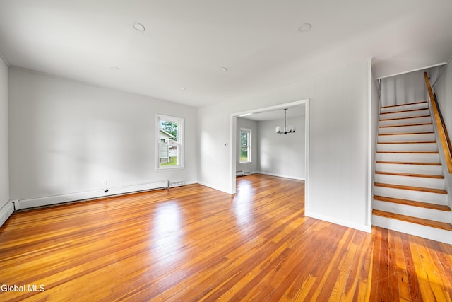 1012 Princetown Rd, Rotterdam, NY 12306 - unfurnished living room featuring stairway, wood finished floors, a chandelier, and baseboard heating