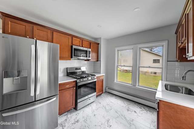 1012 Princetown Rd, Rotterdam, NY 12306 - kitchen with stainless steel appliances, a baseboard heating unit, light marble finish flooring, light countertops, and backsplash