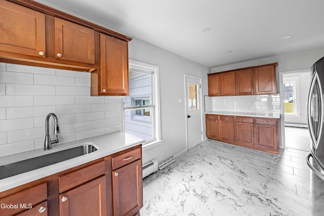 1012 Princetown Rd, Rotterdam, NY 12306 - kitchen with a baseboard radiator, backsplash, light countertops, and brown cabinets
