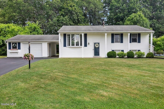 33 Comely Ln, Colonie, NY 12110 - view of front of property with an attached garage, asphalt driveway, a front lawn, and view of wooded area