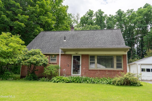 98 Meadowbrook Rd, Saratoga Springs, NY 12866 - view of front of property featuring brick siding, a front yard, and an outdoor structure