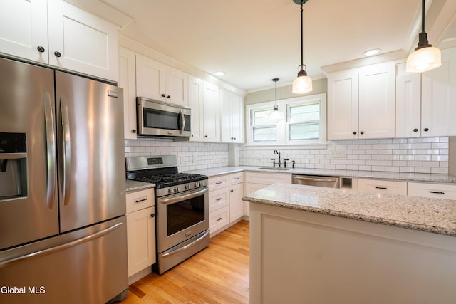 98 Meadowbrook Rd, Saratoga Springs, NY 12866 - kitchen featuring appliances with stainless steel finishes, tasteful backsplash, light wood-style floors, white cabinetry, and recessed lighting