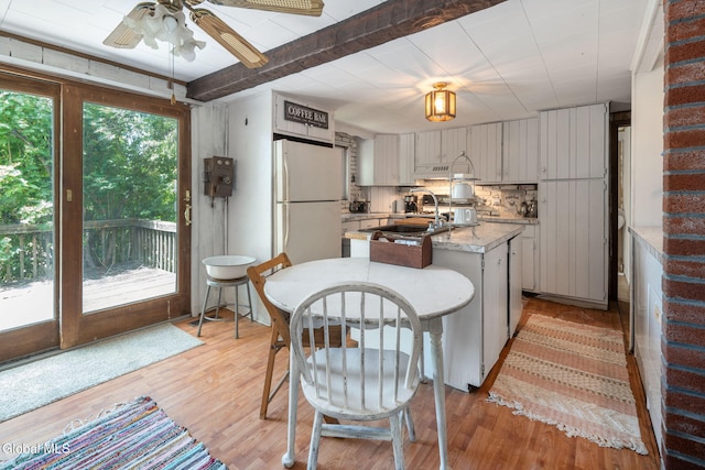 5530 State Highway 30a, Charleston, NY 12066 - kitchen with freestanding refrigerator, a ceiling fan, light wood-style flooring, a center island with sink, and beam ceiling