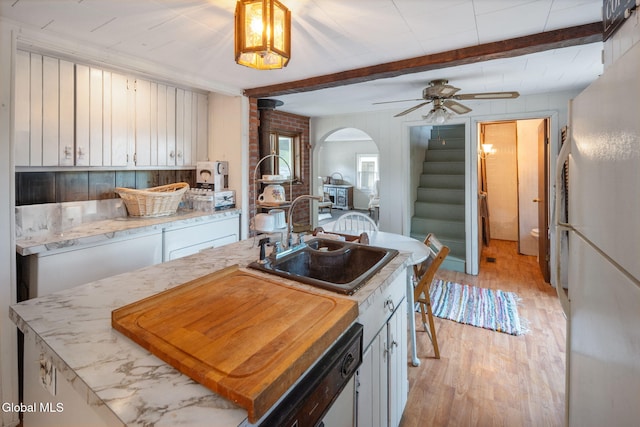 5530 State Highway 30a, Charleston, NY 12066 - kitchen featuring light wood-style flooring, freestanding refrigerator, arched walkways, ceiling fan, and white cabinetry
