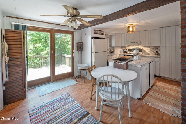 5530 State Highway 30a, Charleston, NY 12066 - kitchen with freestanding refrigerator, light wood-style floors, ceiling fan, an island with sink, and custom exhaust hood
