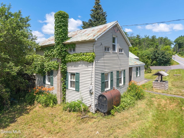 5530 State Highway 30a, Charleston, NY 12066 - view of home's exterior with oil tank, a yard, and a metal roof